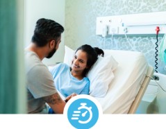 Female in a hospital bed with family/friend holding her hand