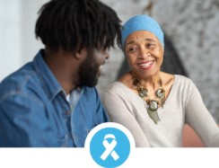 A man and woman sat together and smiling at each other
