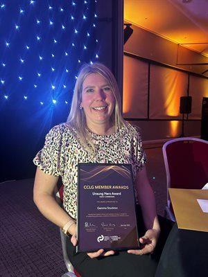 Nurse holding her award
